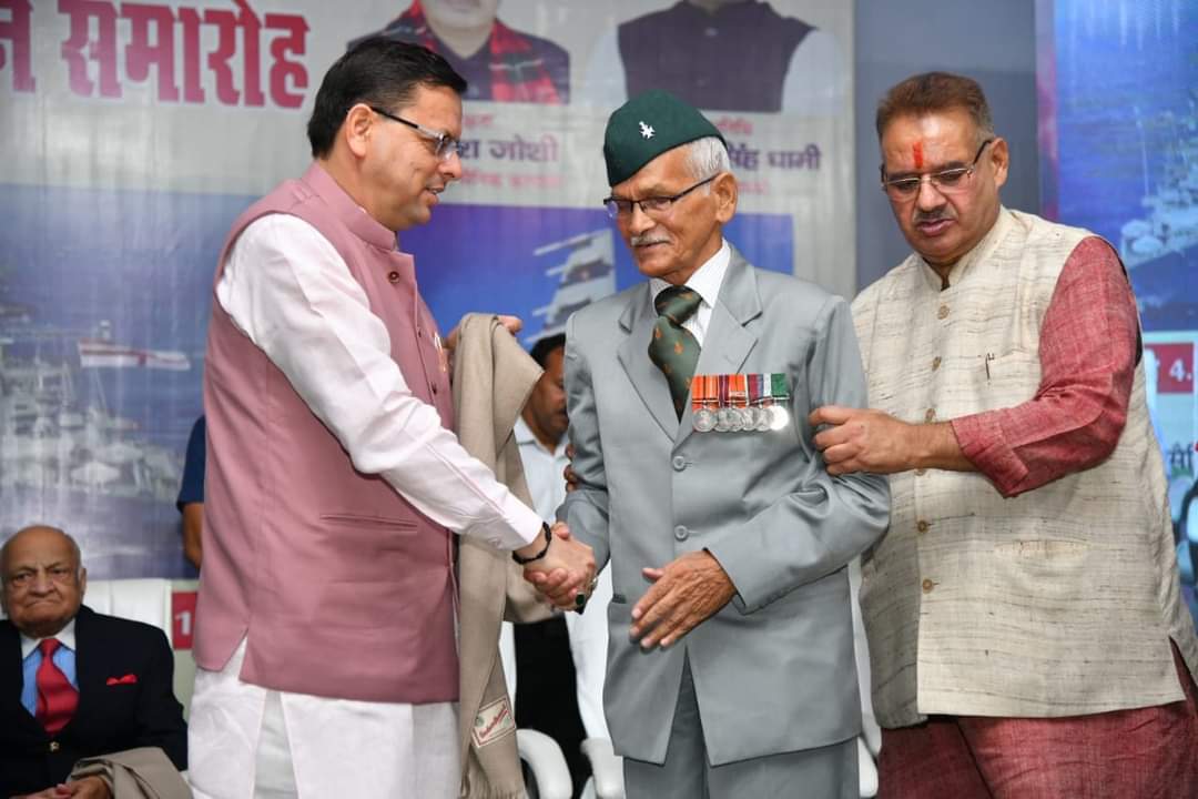 पूर्व सैनिकों को किया सम्मानित करते हुए सीएम धामी और मंत्री गणेश जोशी 